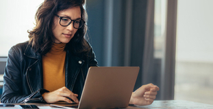 Woman using laptop to review her credit rating after bankruptcy